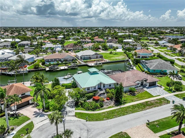 Aerial perspective of suburban area featuring a nearby body of water