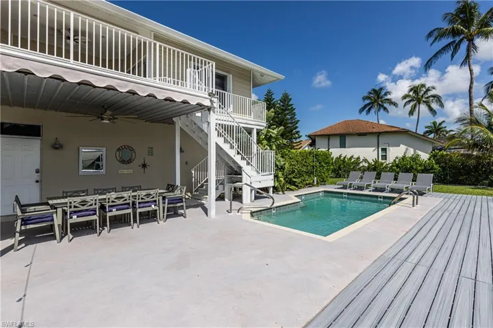 View of pool with a patio, stairway, a ceiling fan, and outdoor dining area