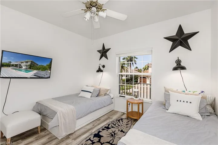 Bedroom with wood finished floors and ceiling fan