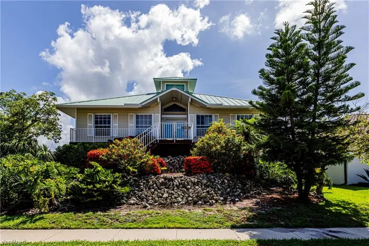 View of front of house featuring a porch and a metal roof