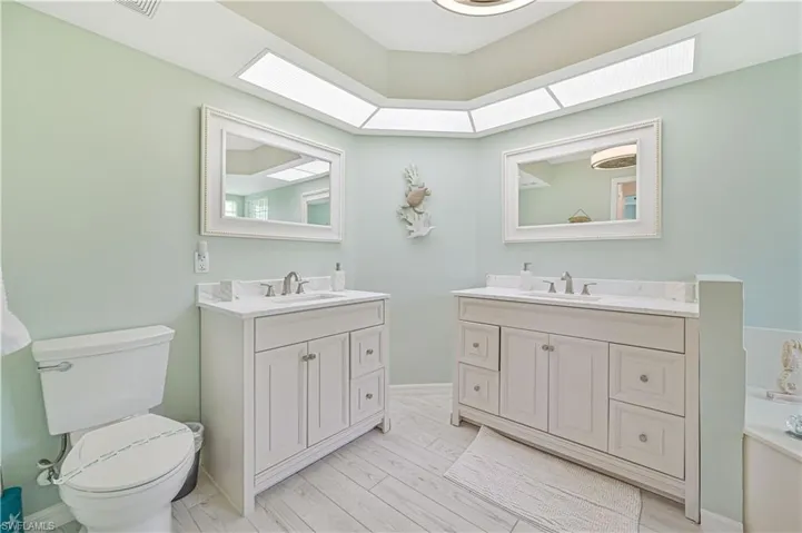 Bathroom with double vanity and toilet