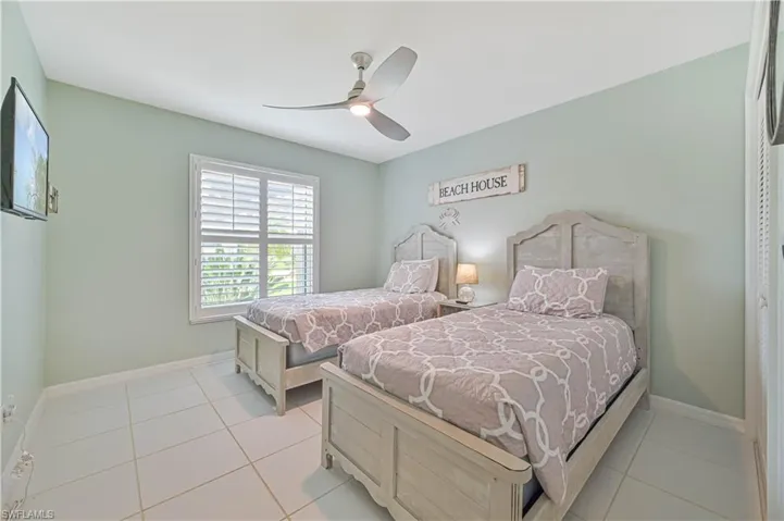 Bedroom featuring light tile patterned flooring and ceiling fan
