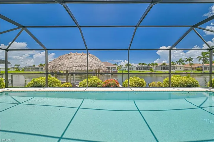View of swimming pool with glass enclosure