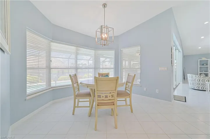 Dining room with an inviting chandelier and light tile patterned floors