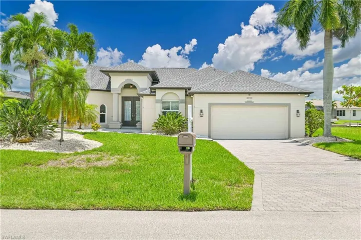 Mediterranean / spanish-style home with a garage and a front yard