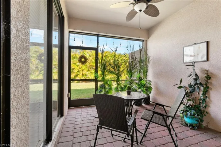 Sunroom / solarium featuring ceiling fan