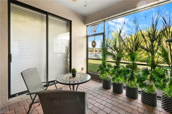 Sunroom / solarium featuring a water view and ceiling fan