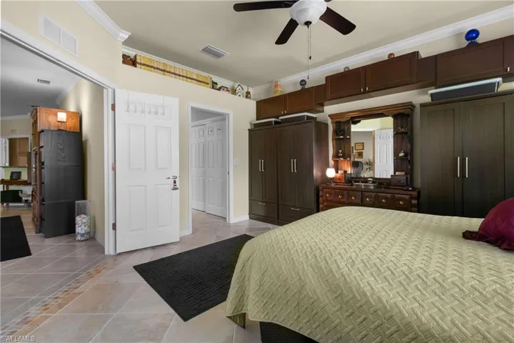 Bedroom featuring ceiling fan and crown molding