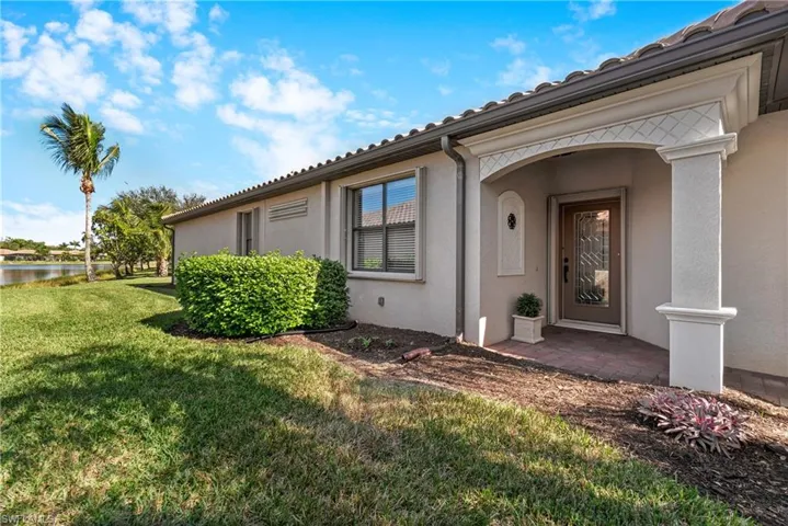 Entrance to property with a lawn