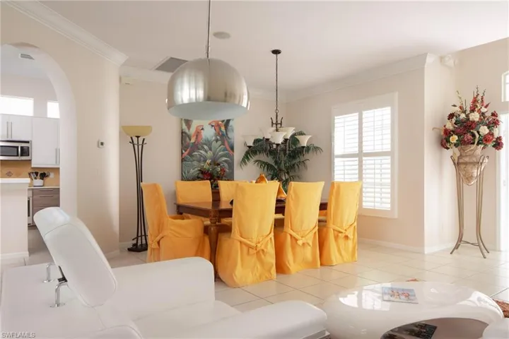 Tiled dining area featuring ornamental molding