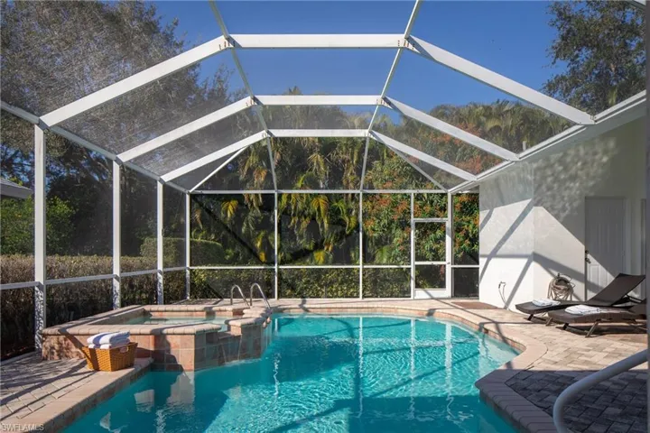 View of pool featuring an in ground hot tub, a lanai, and a patio area