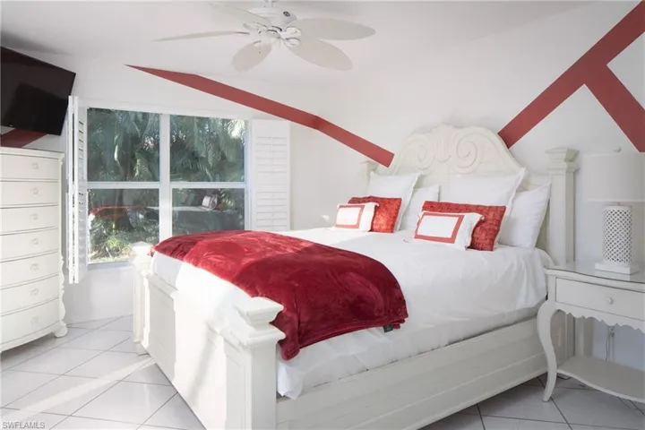 Bedroom featuring light tile patterned flooring and ceiling fan