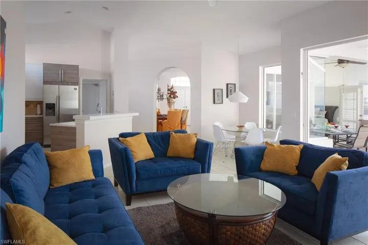 Tiled living room with high vaulted ceiling