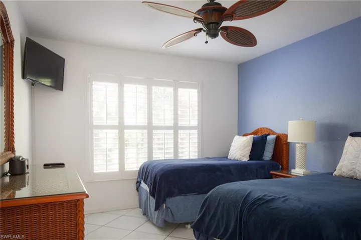 Tiled bedroom with ceiling fan