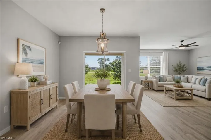 Open-concept living space with wood-finish flooring, a contemporary ceiling fan, and recessed lighting