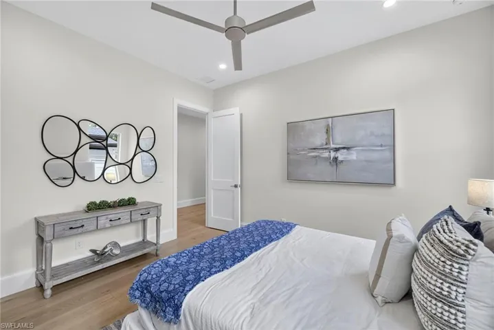 Bedroom with wood finished floors, recessed lighting, and ceiling fan