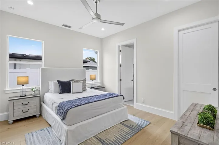 Bedroom with light wood-style flooring, recessed lighting, and a ceiling fan
