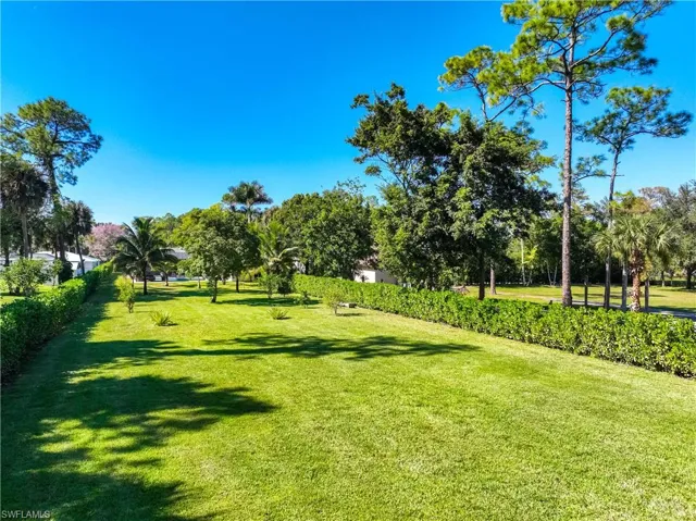 View of property's community with a lawn
