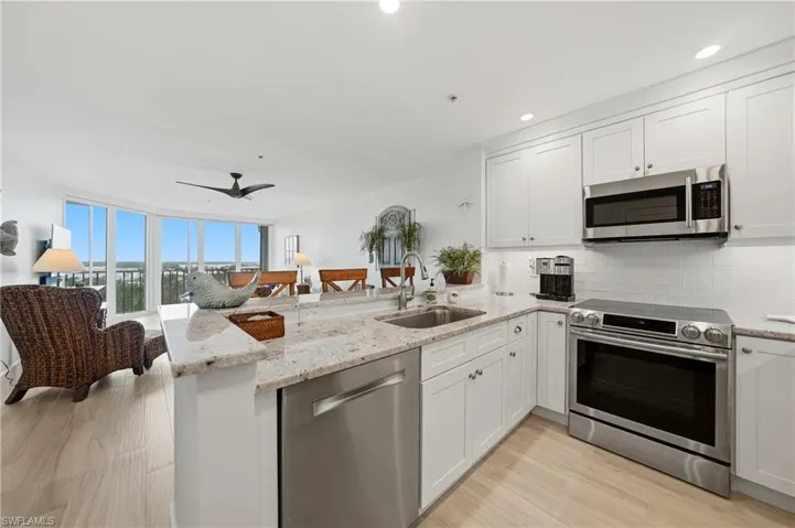 Open Kitchen with Wood Cabinets, Under Cabinet Lighting, Breakfast Bar and Stainless Appliances, Pantry, Tile Flooring