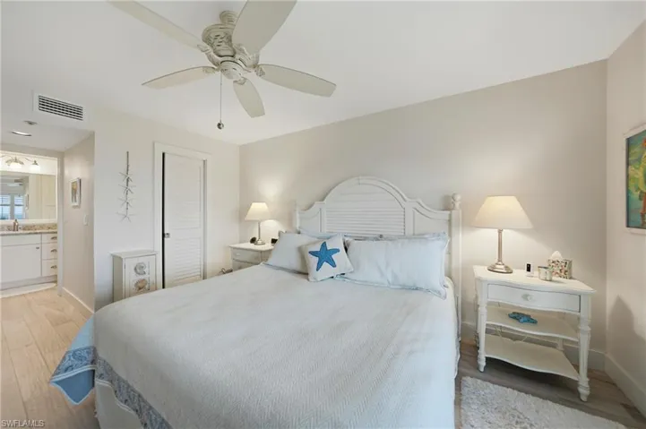 Primary Bedroom with Plantation Shutters, Tile Flooring and Ceiling Fan, Dual Closets