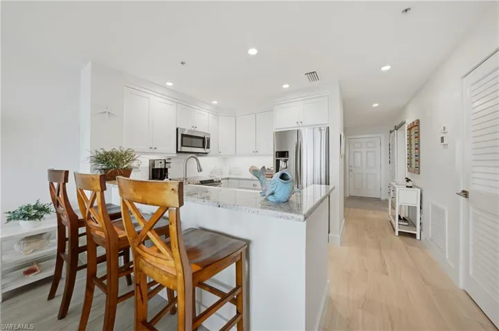 Open Kitchen with Wood Cabinets, Under Cabinet Lighting, Breakfast Bar and Stainless Appliances, Pantry, Tile Flooring