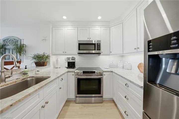 Open Kitchen with Wood Cabinets, Under Cabinet Lighting, Breakfast Bar and Stainless Appliances, Pantry, Tile Flooring