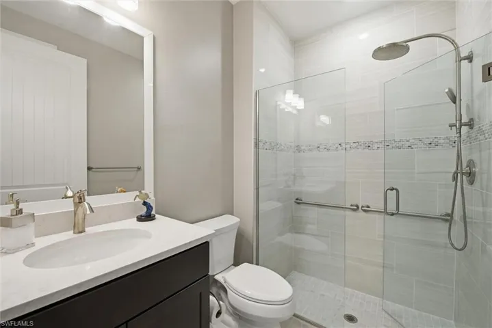 Bathroom featuring vanity and a shower stall