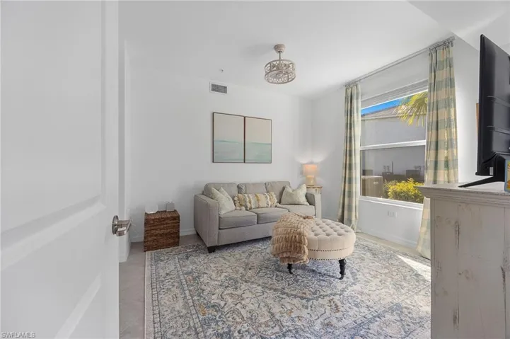 Living room with baseboards and light tile patterned floors