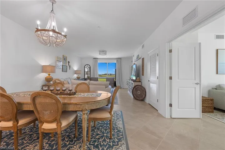 Dining space with a chandelier and light tile patterned floors