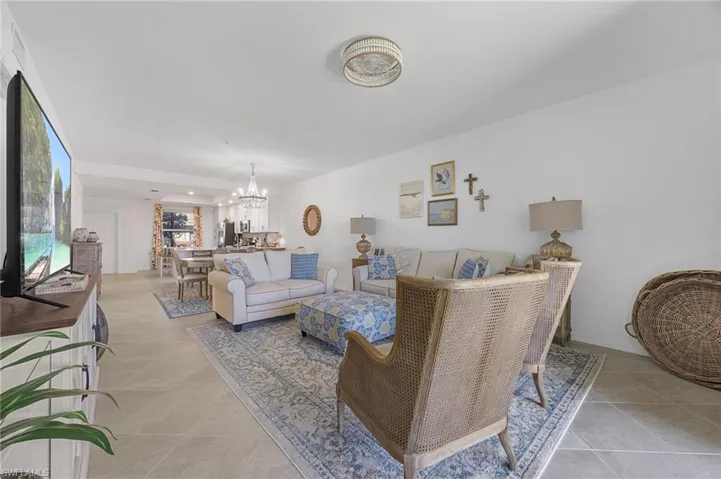 Living room with a chandelier and light tile patterned floors
