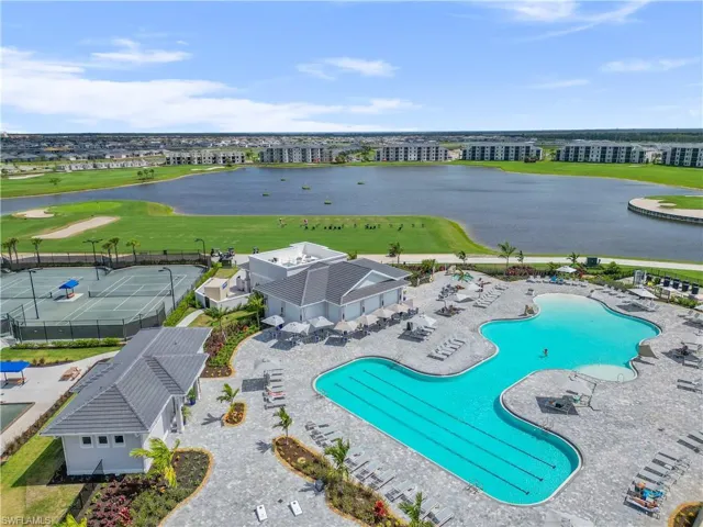Community pool featuring a water view, view of golf course, and a patio