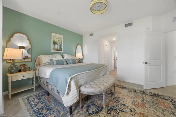 Bedroom featuring light tile patterned floors and a closet