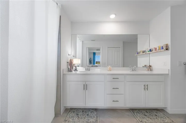 Bathroom featuring double vanity and a shower with curtain