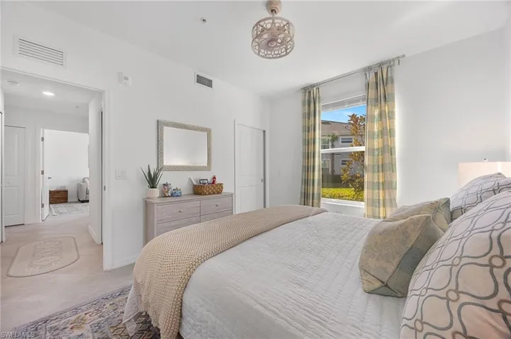 Bedroom with baseboards and tile patterned floors