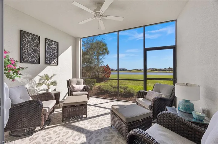 Sunroom / solarium with an outdoor hangout area, a ceiling fan, and a water view