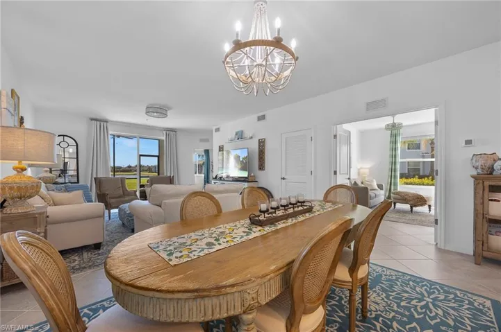 Tiled dining room with a chandelier
