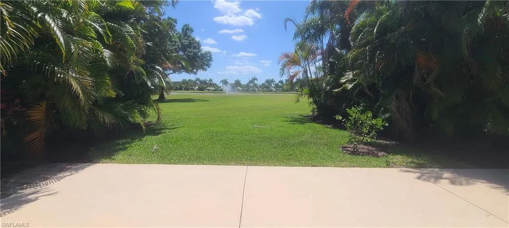 View of home's community with a lawn