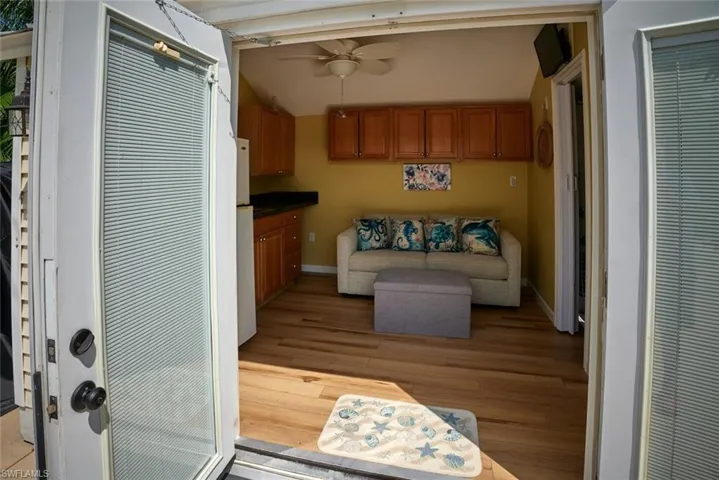 Kitchen with ceiling fan, vaulted ceiling, and light wood-type flooring