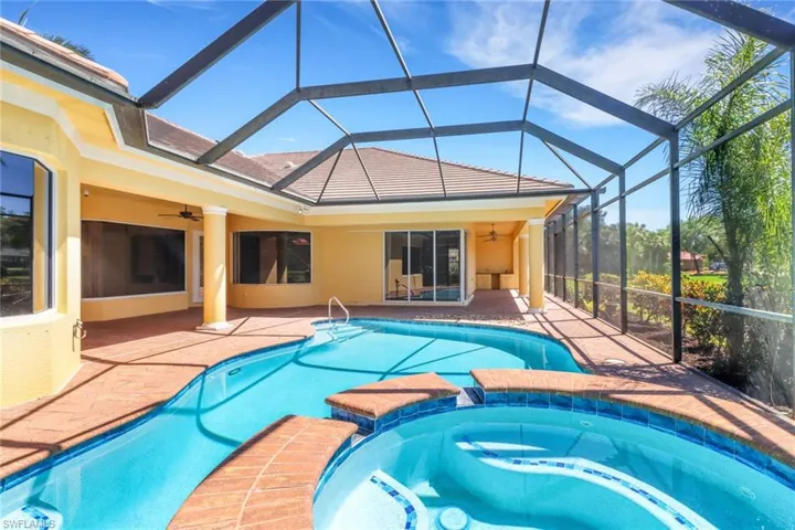 Large entertaining space with outdoor kitchen and outdoor shower, plus access to full pool bath from outside.