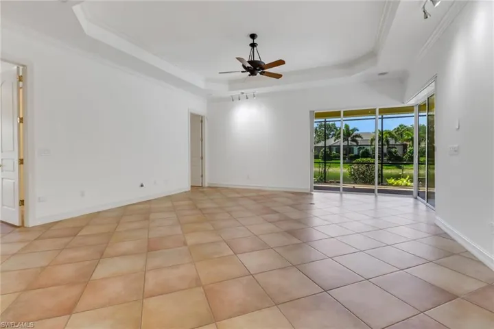 Large open living space with beautiful tall trayed ceilings