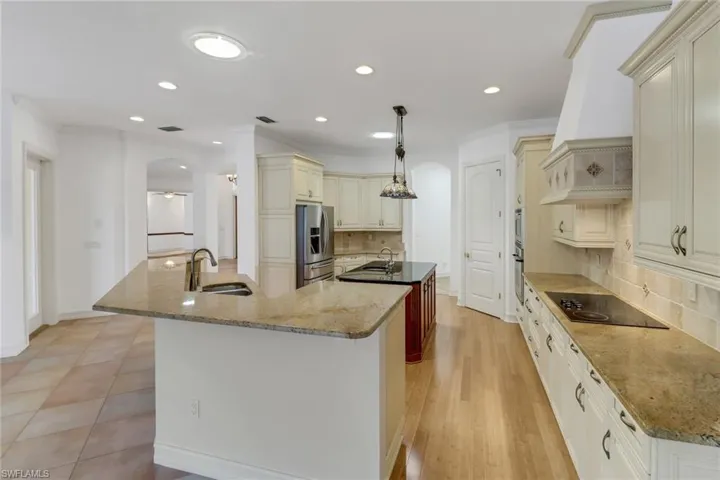 Large chef's kitchen with island, two sinks, large walk in pantry and tons of cabinet space.