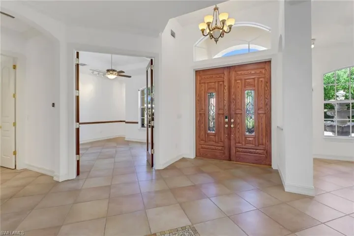 Impressive 18 foot ceilings as you enter the double doors of this home.