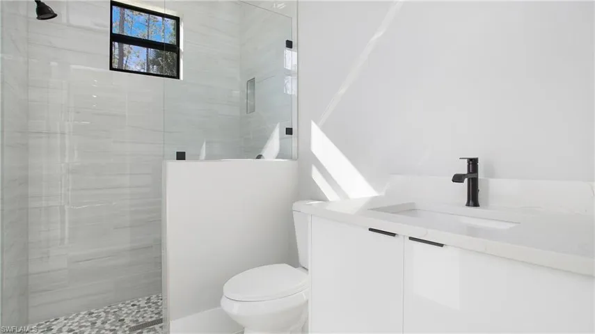 Full bathroom featuring a walk in shower and vanity