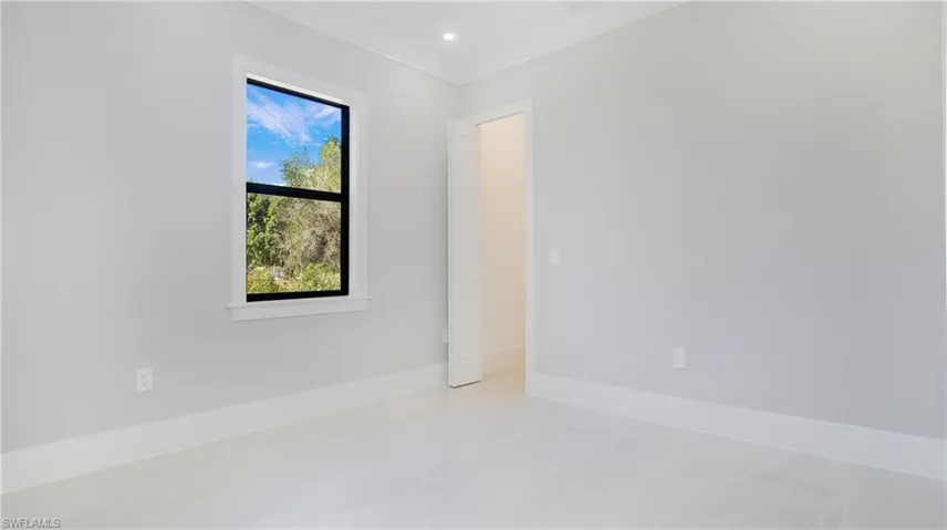 Unfurnished room with baseboards and recessed lighting