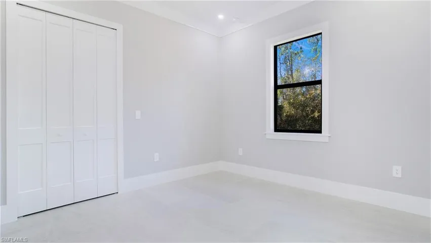 Unfurnished bedroom with a closet and recessed lighting
