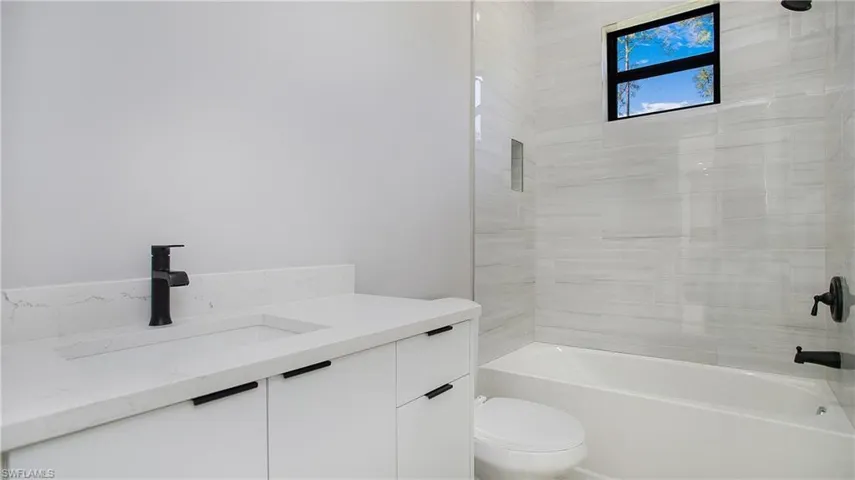Bathroom with vanity and  shower combination