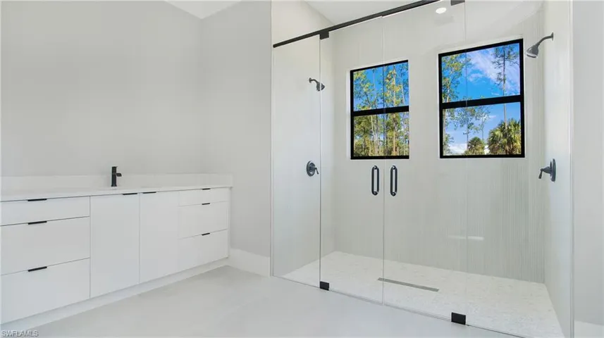 Bathroom featuring vanity and a shower stall