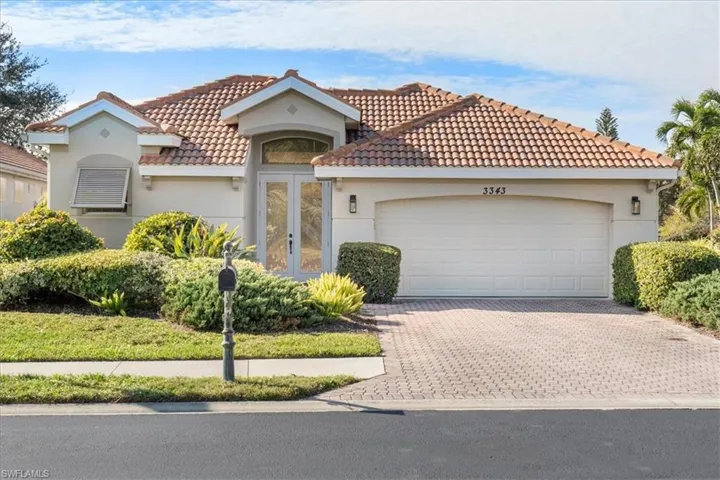 Mediterranean / spanish-style house featuring french doors and a garage
