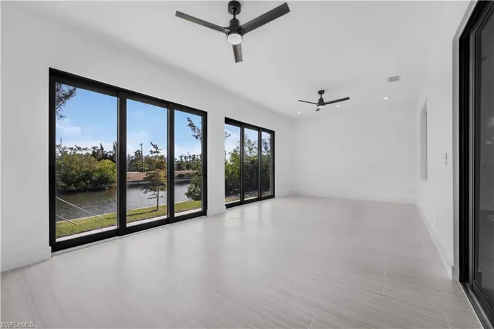 Spare room featuring a water view and ceiling fan