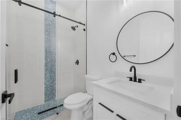 Full bath room  featuring a stall shower and vanity